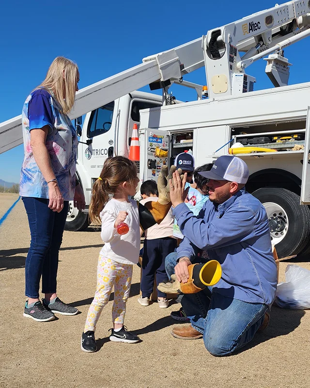 TRICO_HOME_Touch a Truck event at Dove Mountain School Anthony Anaya high fives a girl